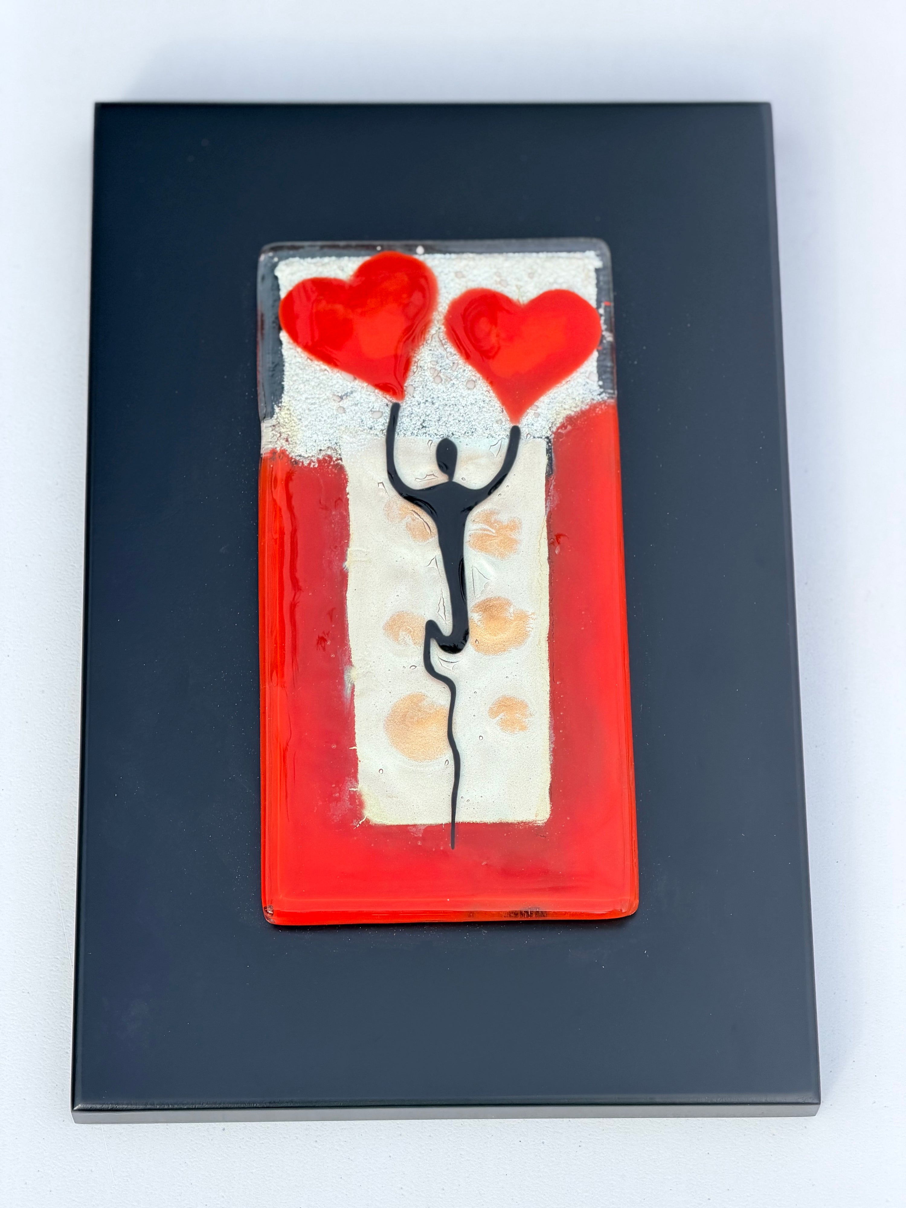 Figure Holding Hearts - Fused Glass Wall Art with Black Panel